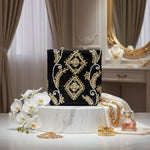 The black velvet tote bag with gold and white floral hand embroidery and beaded details.
