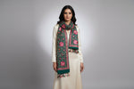 The bottle green Kashmiri embroidered pashmina scarf with tassels hanging at the ends, displayed on a wooden surface.