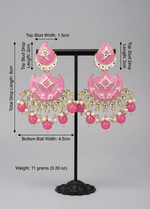 The enamel painted pink colour Pair of earrings displayed on a stand. 