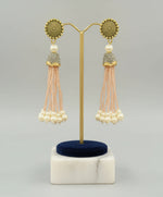 The gold-plated Kundan-studded and pearl-beaded handcrafted earrings, displayed against a black background. Party wear set. 