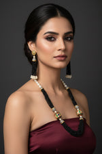 The luxurious Tanjore Art Meenakari beaded Mala Set featuring a bridal pearl necklace with accompanying earrings, predominantly in gold and white colours with ornate designs.