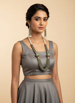 The luxurious Tanjore Art Meenakari grey beaded Mala Set featuring a bridal pearl necklace with accompanying earrings, predominantly in gold and white colours with ornate designs.