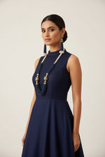 The luxurious Tanjore Art Meenakari navy blue beaded Mala Set featuring a bridal pearl necklace with accompanying earrings, predominantly in gold and white colours with ornate designs.