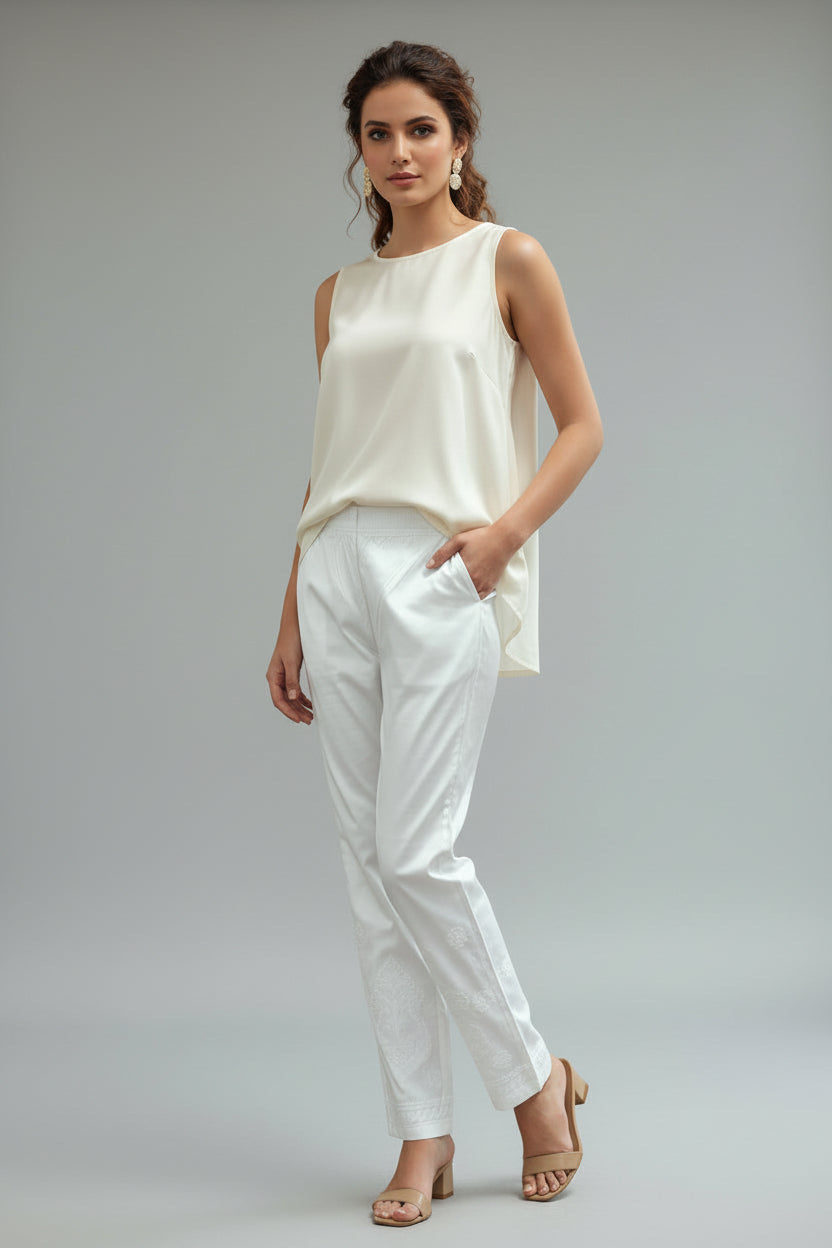 The pair of White stretchable cotton hand embroidered chikankari pants with pockets.