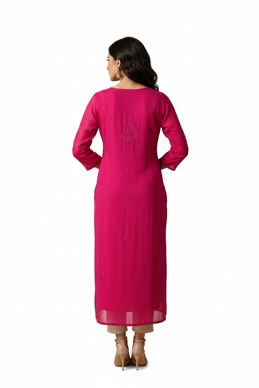 The rear view of bright pink sheer long-sleeve dress or kurta hanging on a white hanger against a black background, with a small embroidered motif at the centre chest.