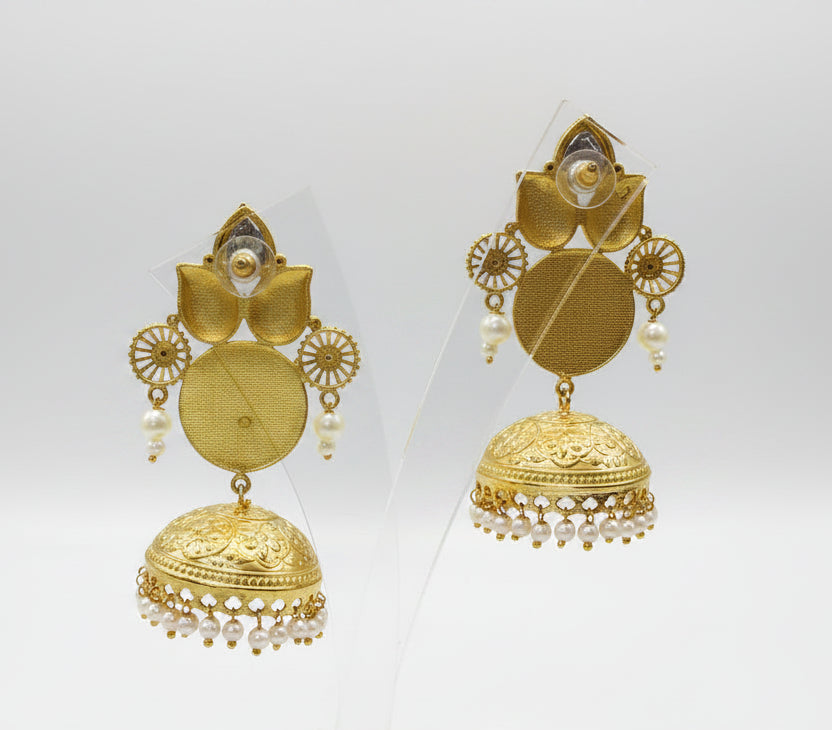 The rear view of the Gold plated pairt of jhumkas displayed on a stand to show the rear side of the earrings. 