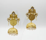 The rear view of the Gold plated pairt of jhumkas displayed on a stand to show the rear side of the earrings. 