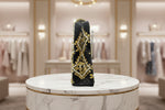 The side view of a black velvet tote bag with gold and white floral hand embroidery and beaded details.