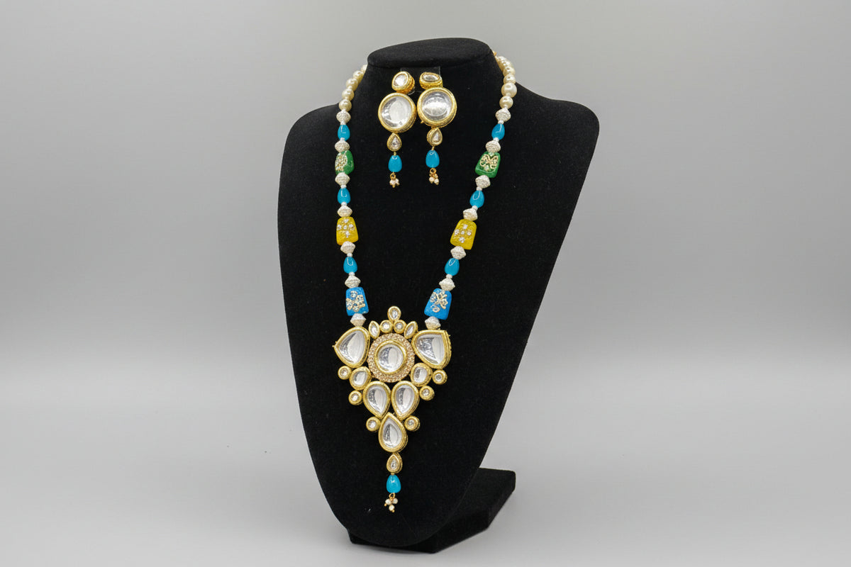 The traditional bridal necklace set displayed on a mannequin, featuring sky blue and gold colours with intricate detailing and pearl beads. Party wear jewellery set. 