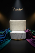 The white clutch bag with glass bead embroidery, featuring a chain strap and a zipper closure.