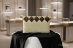 The white clutch bag with multi-coloured nano glass beads patterns, hand embroidered, displayed outdoors.