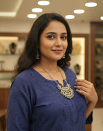 Traditional Indian pendant styled with a white linen shirt for a modern look