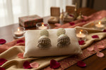 Traditional bell-shaped jhumkas with a cream-based floral print and silver ghungroo bead detailing.