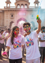 Two people celebrating Holi festival with colorful powder and paint in front of a historic building.