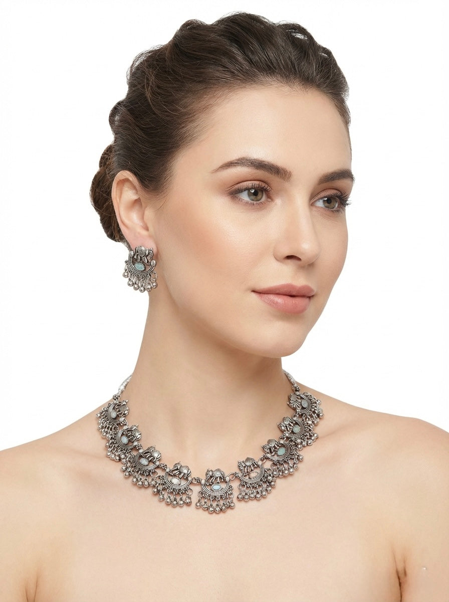 Vintage oxidised silver elephant motif necklace set on model for Indian festival wear in London UK
