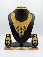 Wareesha Grand Filigree Gold-Plated Jewelry Ensemble by Famaza Couture displayed elegantly on a posh stand.