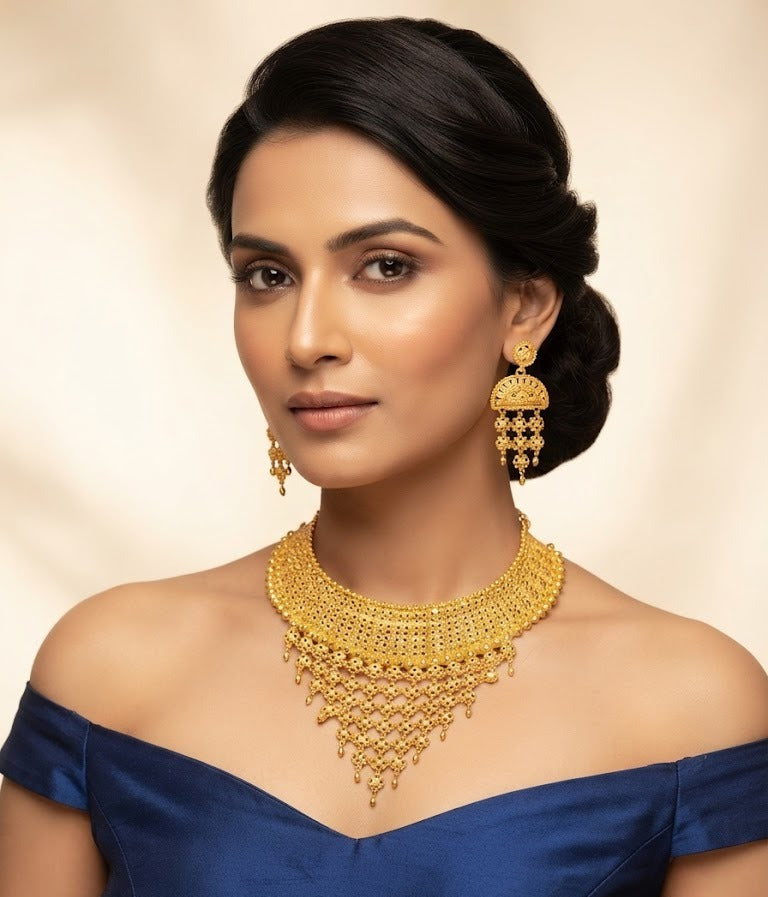 Posh model wearing the Wareesha heritage filigree micro gold-plated statement necklace and earring set by Famaza Couture on a plain background.