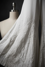 Close-up of white-on-white floral and paisley embroidery on Ivory Reverie sharara trousers.