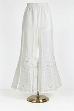 White pure cotton sharara, detailed with fine white thread Bakhiya embroidery and elegant antique gold Kaamdani work, featuring classic paisley motifs, flared silhouette, soft lightweight fabric — perfect for traditional, festive and everyday wear