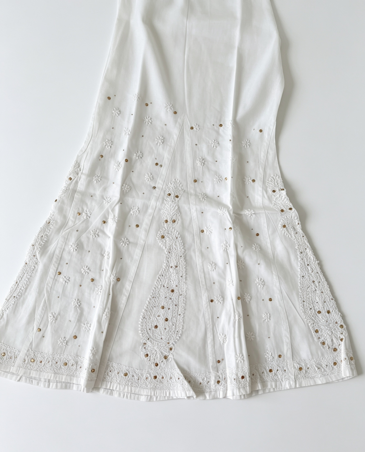 White pure cotton sharara featuring fine white thread Bakhiya embroidery, intricate antique gold Kaamdani detailing, flared silhouette, lightweight fabric – ideal for festive, casual and traditional wear.