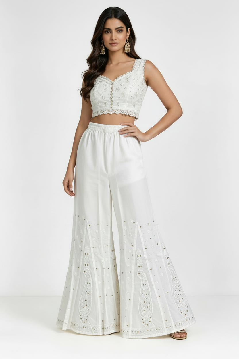 White pure cotton sharara, beautifully crafted with intricate white thread Bakhiya embroidery and detailed antique gold Kaamdani work, featuring a flared silhouette, lightweight and soft fabric — ideal for traditional, festive and casual wear