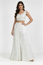 White pure cotton sharara, beautifully crafted with intricate white thread Bakhiya embroidery and detailed antique gold Kaamdani work, featuring a flared silhouette, lightweight and soft fabric — ideal for traditional, festive and casual wear
