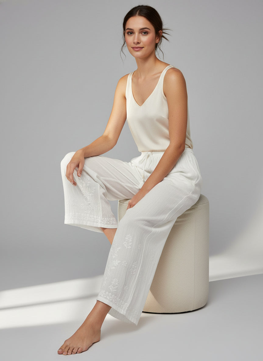 White colour reyon fabric hand embroidered trousers by famaza couture 