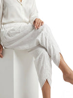 White lace-trimmed pants on a white background