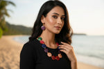 Woman wearing a colorful beaded necklace and earrings.