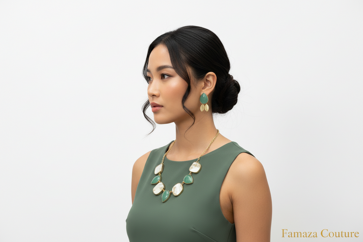Woman wearing a green dress and gold necklace with green stones on a white background