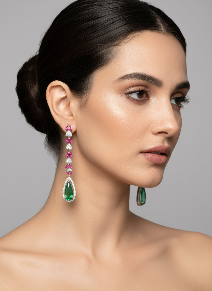 Woman wearing a pair of earrings with gemstones 