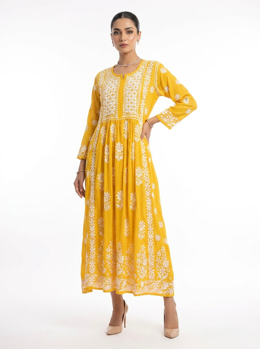 Woman wearing a yellow dress with white floral patterns on a white background