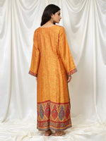 Woman wearing and showing the rear view of the original kanni silk long kurti with it's full elegance. 