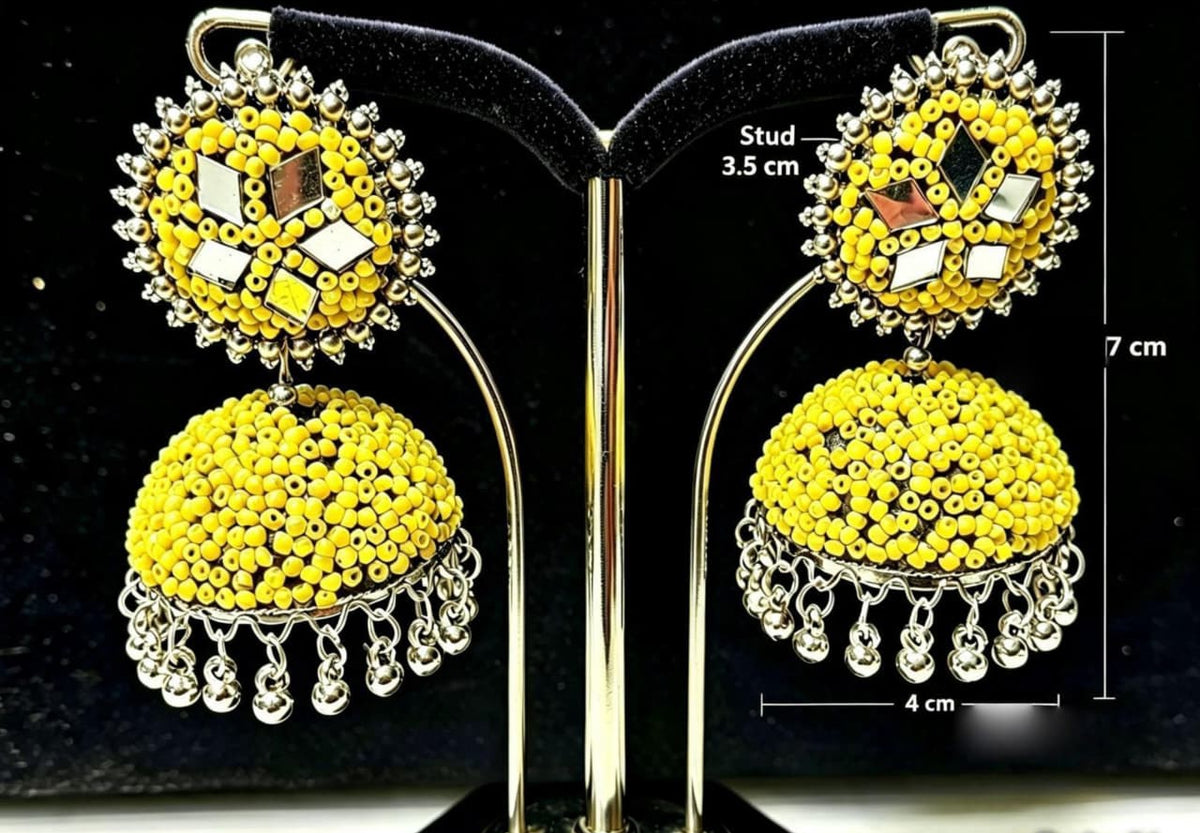 Model wearing Yellow Mirror Work Beaded Jhumka Earrings — 3.5cm Stud, 7cm Drop, 4cm Width — Handcrafted Ethnic Jewelry with Silver Accents.