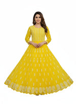 Yellow dress with white embroidery on a decorative background