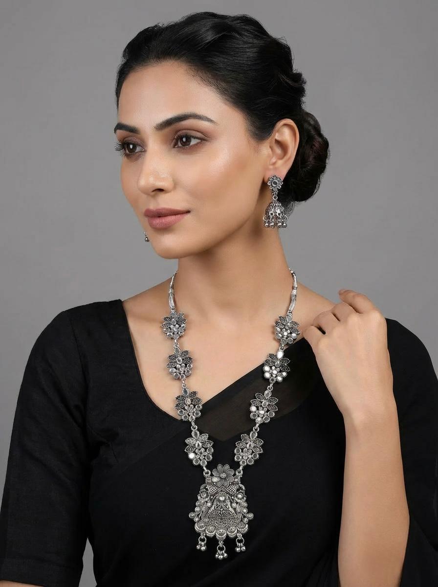 Young woman wearing an Antique Finish Floral Lattice Necklace and Jhumka set, styled as posh evening jewellery for a bridal or party wear look, British English fashion photography.