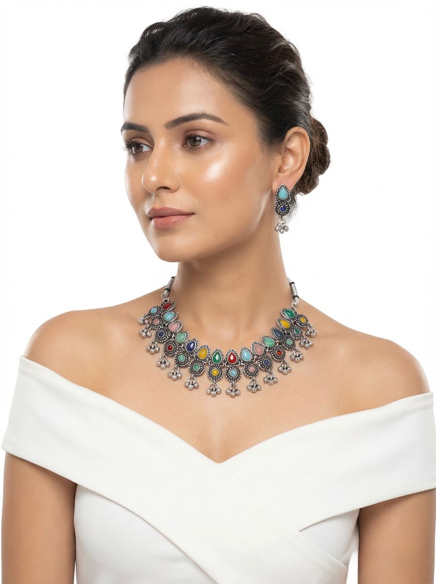 Young woman wearing the Sienna artisanal multicolour silver oxidised choker and drop earrings, styled for an elite evening jewellery look.