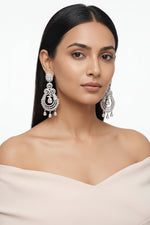 Stunning silver-plated American Diamond statement chandelier earrings with a floral stud, scrollwork motifs, and dangling CZ teardrops.