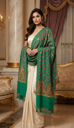 Woman wearing a green and red patterned shawl over a white outfit in an elegant room.