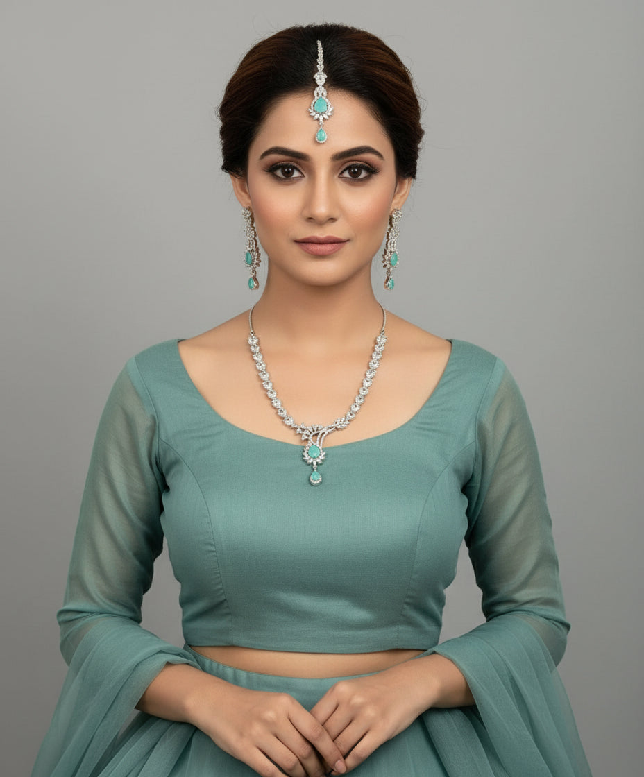 a rhodium-plated brass jewellery set with American diamond and semi-precious turquoise stones, including a necklace, earrings, and maang tikka by Famaza couture 