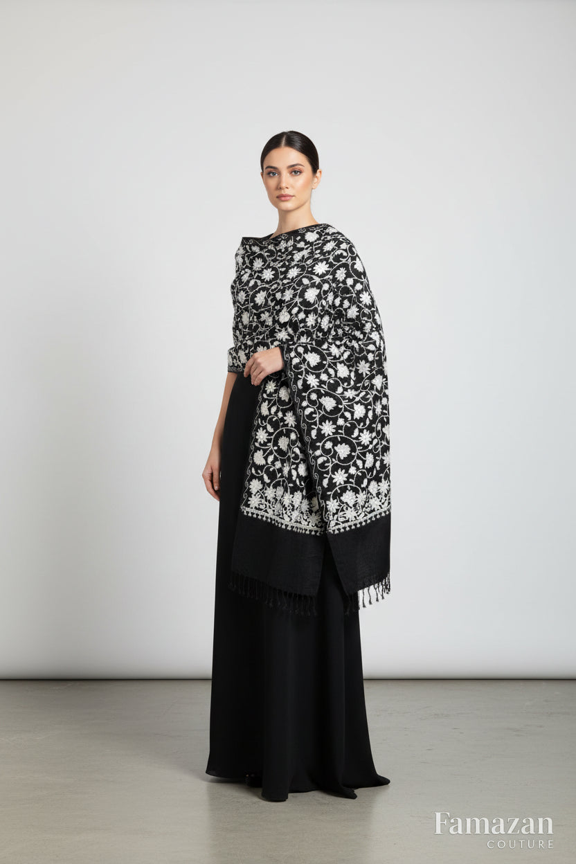 black Kashmiri white embroidered pashmina scarf featuring floral patterns and tassels.