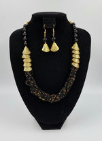 black braided necklace with gold accents and matching earrings by famaza couture 
