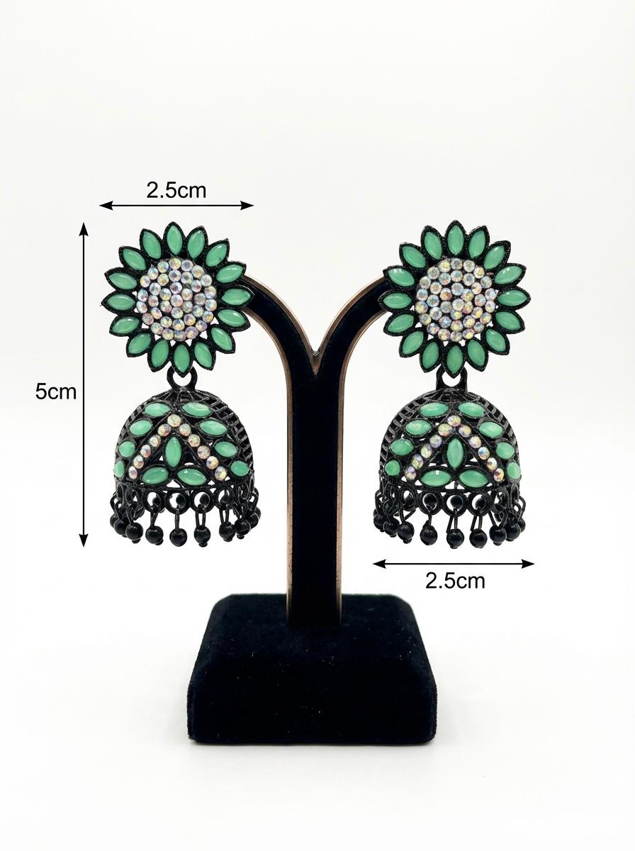 Elegant black brass jhumka earrings featuring a refreshing mint green stone floral stud and matching mint stone inlay on the jhumka dome.