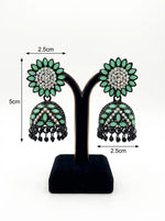 Elegant black brass jhumka earrings featuring a refreshing mint green stone floral stud and matching mint stone inlay on the jhumka dome.