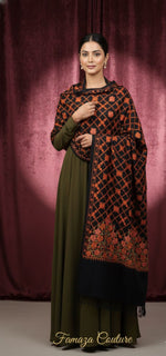 Woman wearing a patterned outfit with a dark background, featuring the brand 'Famaza Couture'.