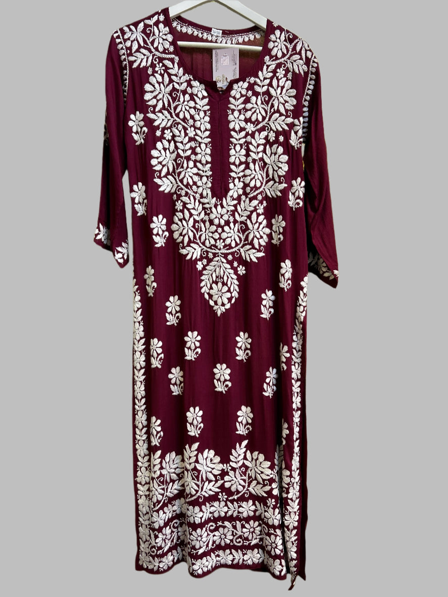 A fully embroidered maroon kurti with floral motifs and detailed border work