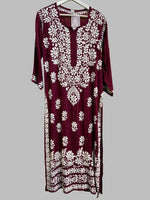 A fully embroidered maroon kurti with floral motifs and detailed border work