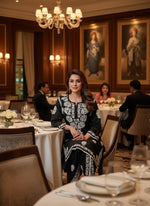 Chikankari kurti with dhoti pants set in black on a mannequin