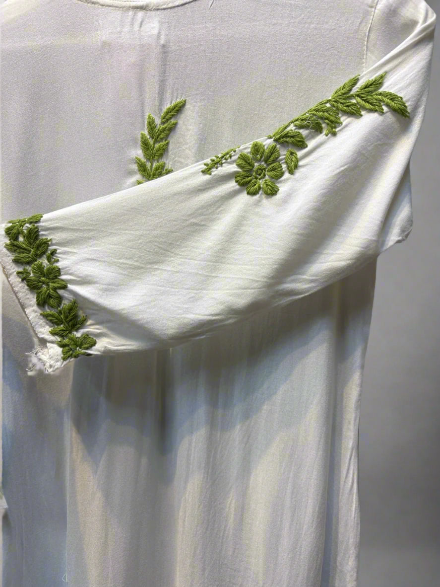 Chikankari kurti with green colour embroidery on white sleeve close up