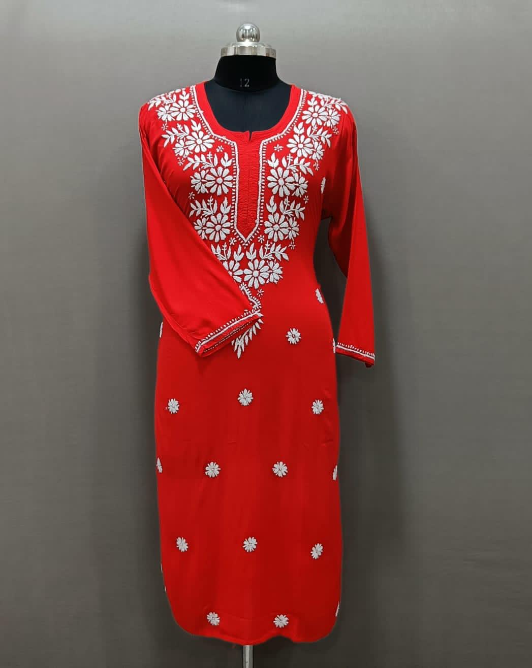 A red modal chikankari kurti with white hand embroidery in a Ghass Patti pattern and booti work.